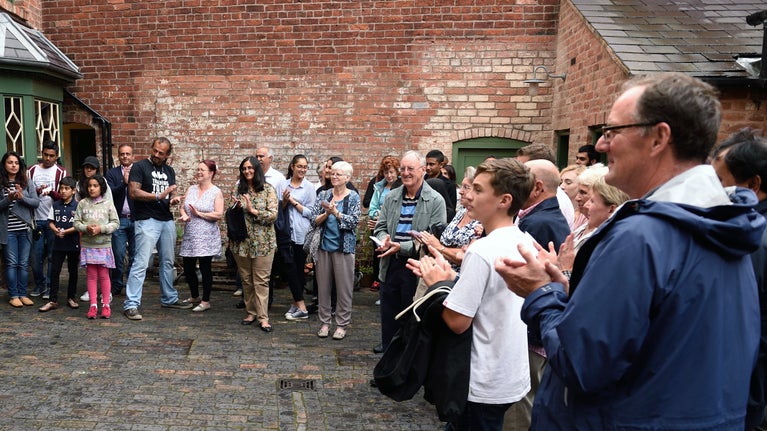 A group of visitors listening to a guided tour